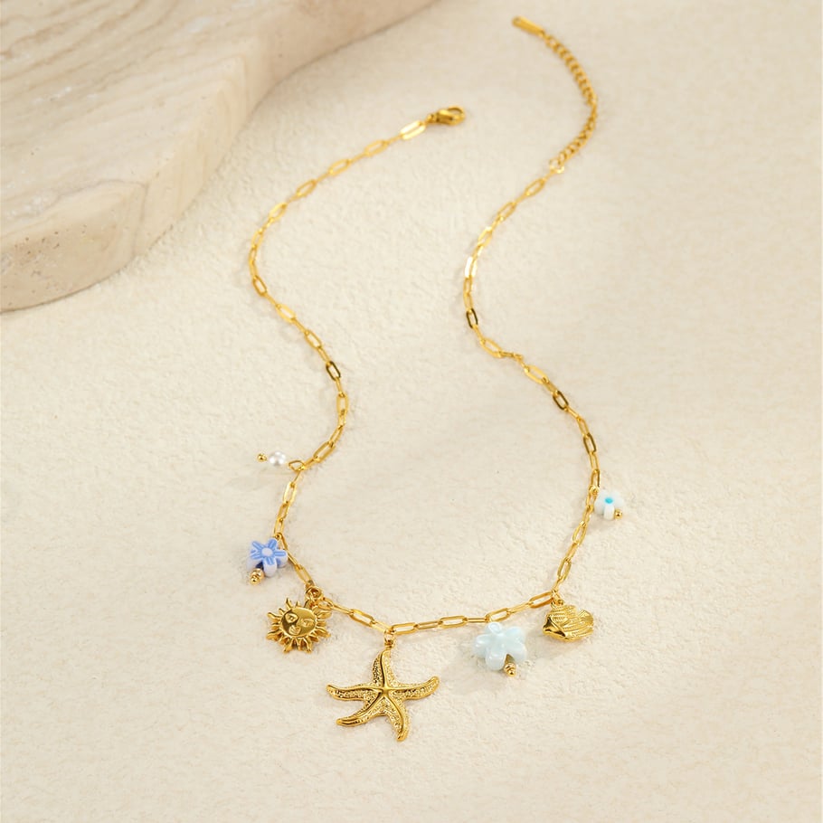 Bedelketting zeester met blauwe details goud